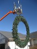 IMG_2157 This was the old way of putting in the mega wreath.  We had to use a rope tied to a lift and gently put it in place.  A gin pole is now used instead.