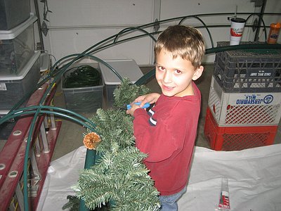 Wyatt helping to attach the garland