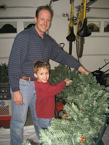 Putting garland on the wreath in the garage