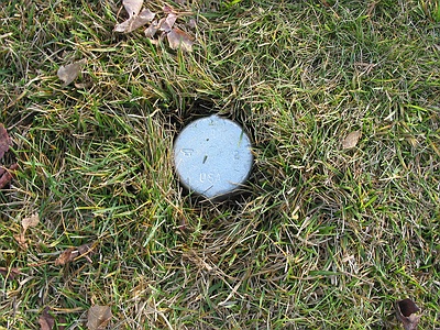 Cap on sleeve in ground